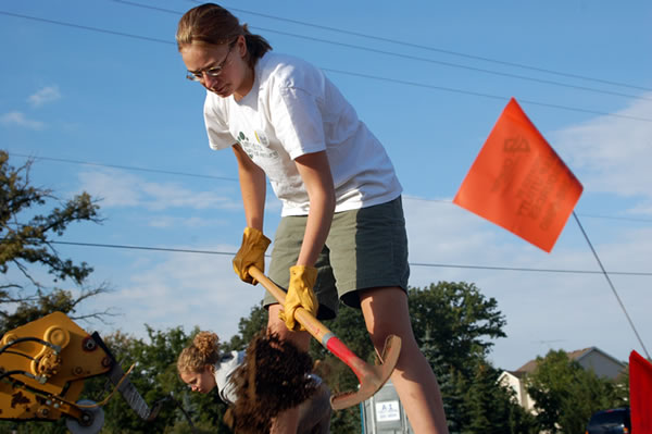 Sara Asfeld works carefully in a trench that passes near utility lines