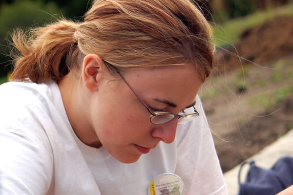 Sara, who is majoring in accounting, studies her volunteering paperwork 